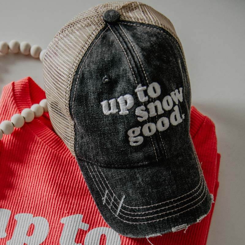 up to snow good trucker hat and corded sweater