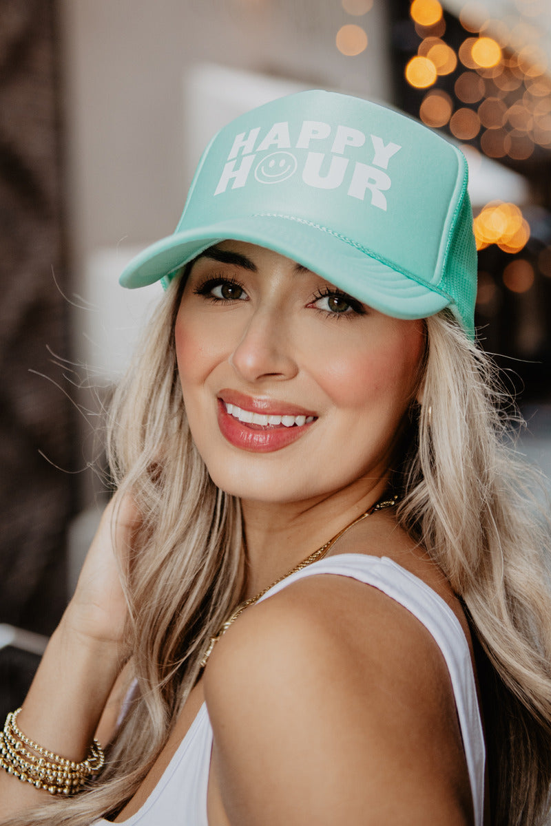 A woman wearing a foam happy hour baseball cap