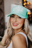 A woman wearing a foam happy hour baseball cap
