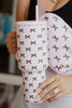 Woman holding a pink & black coquette bow tumbler
