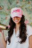 A woman wearing a pink Margs trucker hat